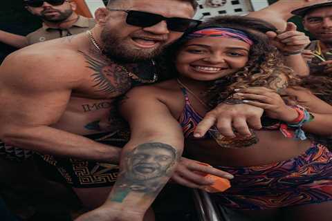 Topless Conor McGregor poses with woman who has incredible tattoo of UFC legend during wild..