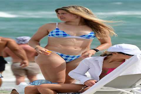 Genie Bouchard stuns in blue bikini on Miami beach before being fed sushi and cuddling male friend..