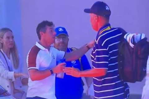 Raging Rory McIlory held back and bundled into car after aggressively pointing at rival as he..